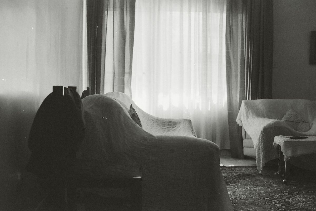 Living room furniture covered with sheets