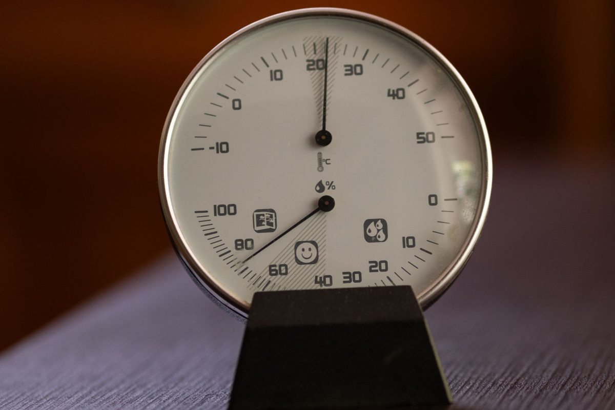Round dial hygrometer and thermometer on a stand