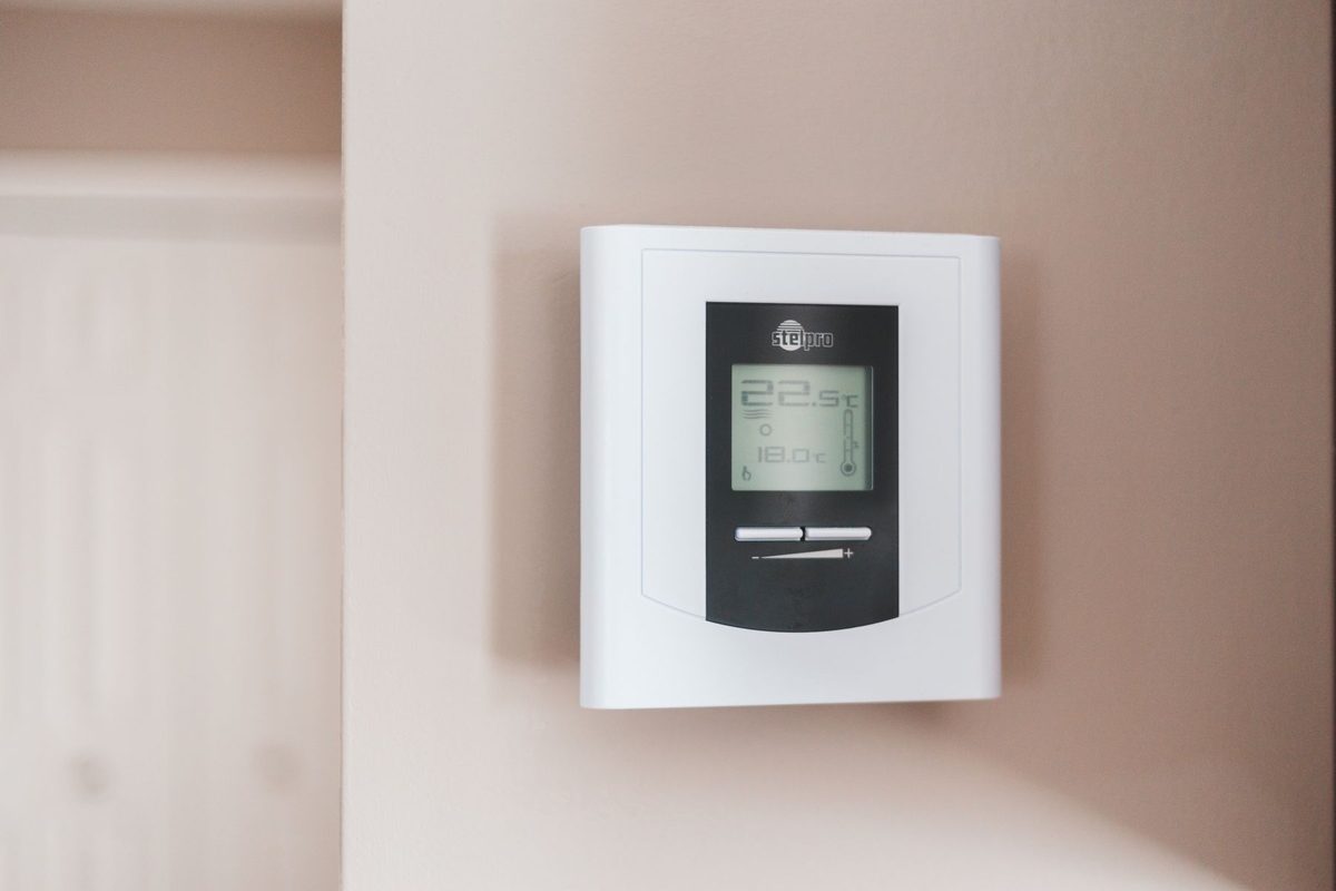 White wall thermostat with a digital display