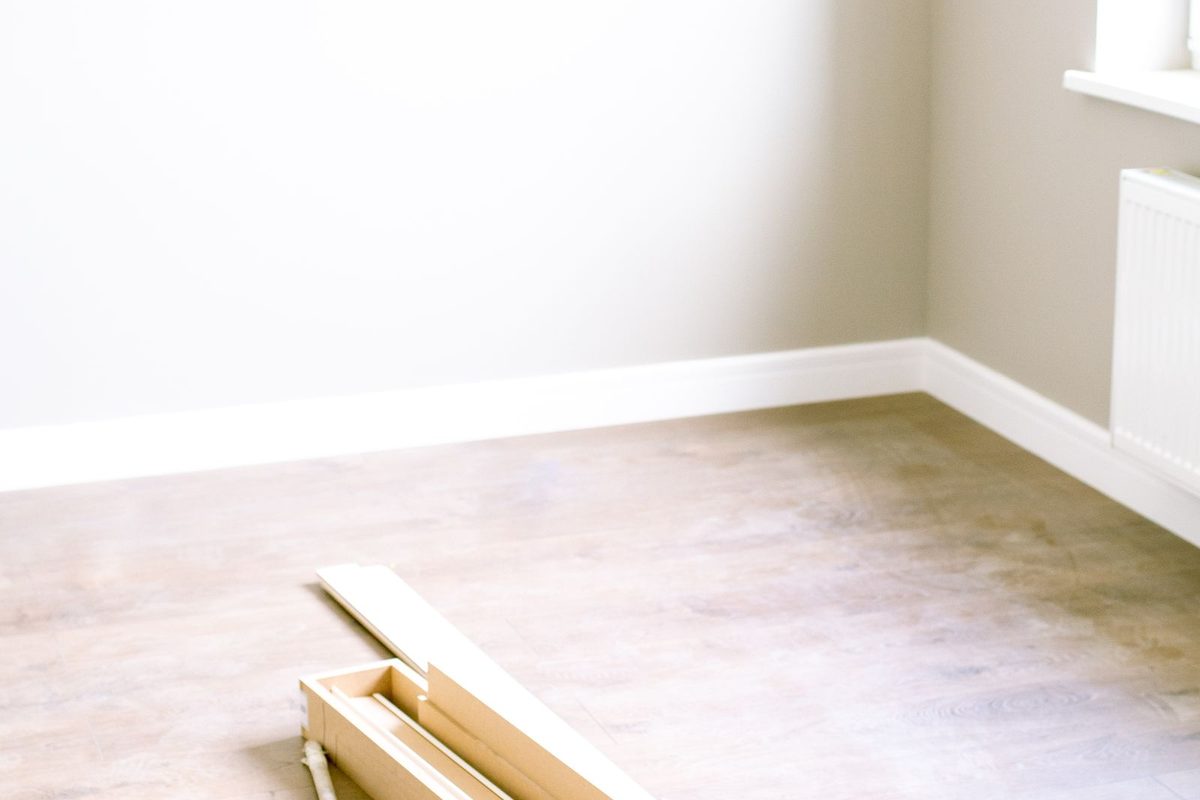 Loose wood floor planks lying in an empty room