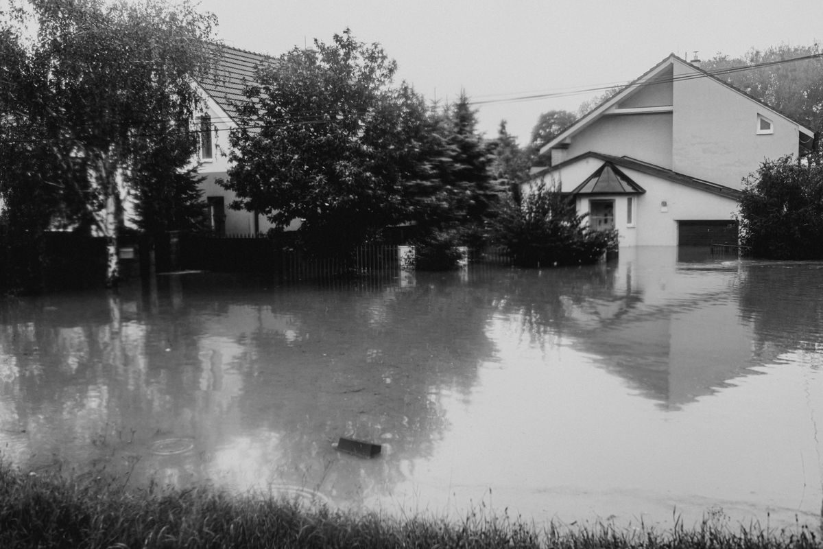 Flooded street with houses standing in floodwater