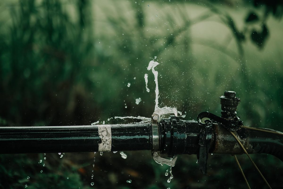 Water spraying from a leaking joint in a pipe