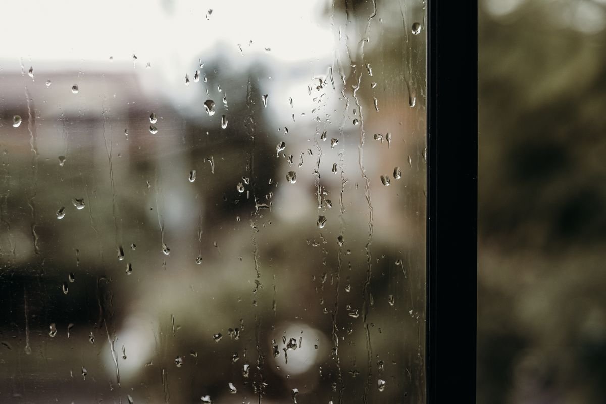 Raindrops on a sliding glass door during a storm