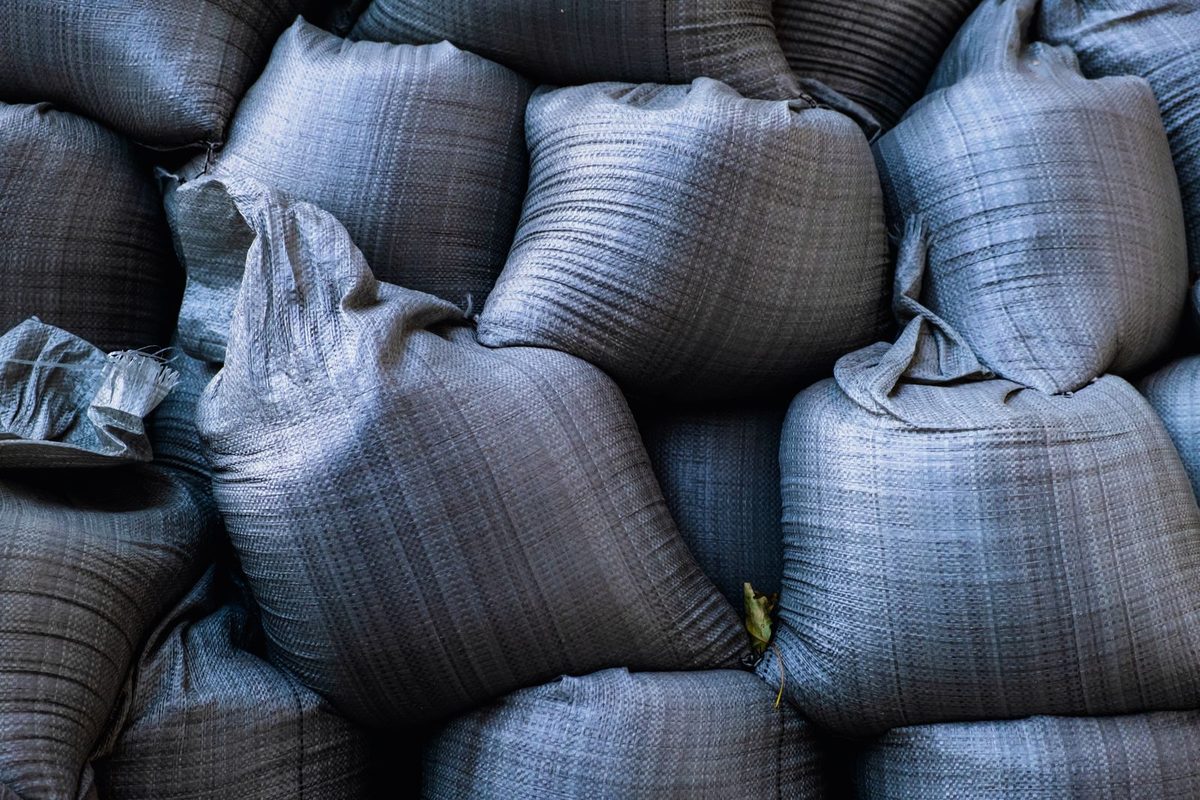 Close-up of stacked gray sandbags