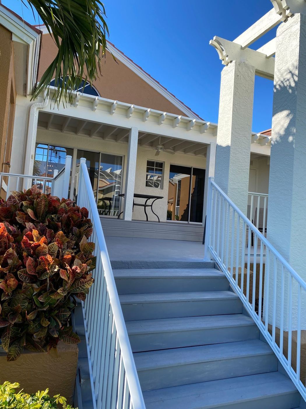Porch stairs: New stairs and white railing