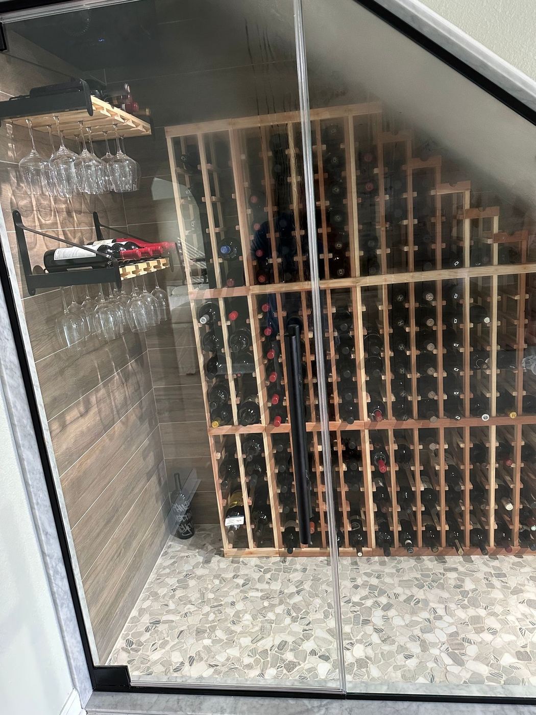 Custom wine racks behind glass